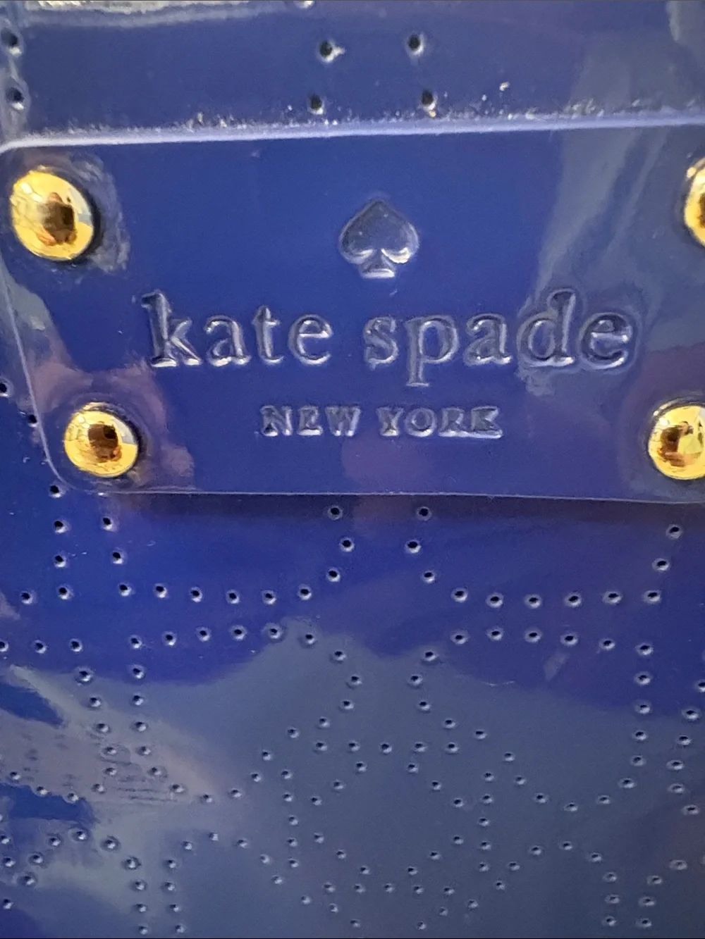 Kate Spade heart perforated patent leather crossbody in cobalt blue.